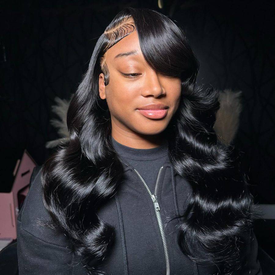 Close-up of a model showcasing the HD lace frontal wig in jet black with body wave curls. The 13x4 lace front offers a natural and flawless finish.