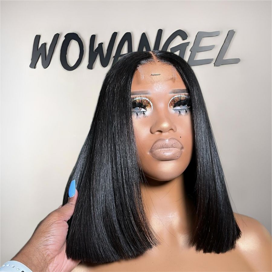 Mannequin head with a black wig held by a hand, against a neutral background with 'WOWANGEL' branding.