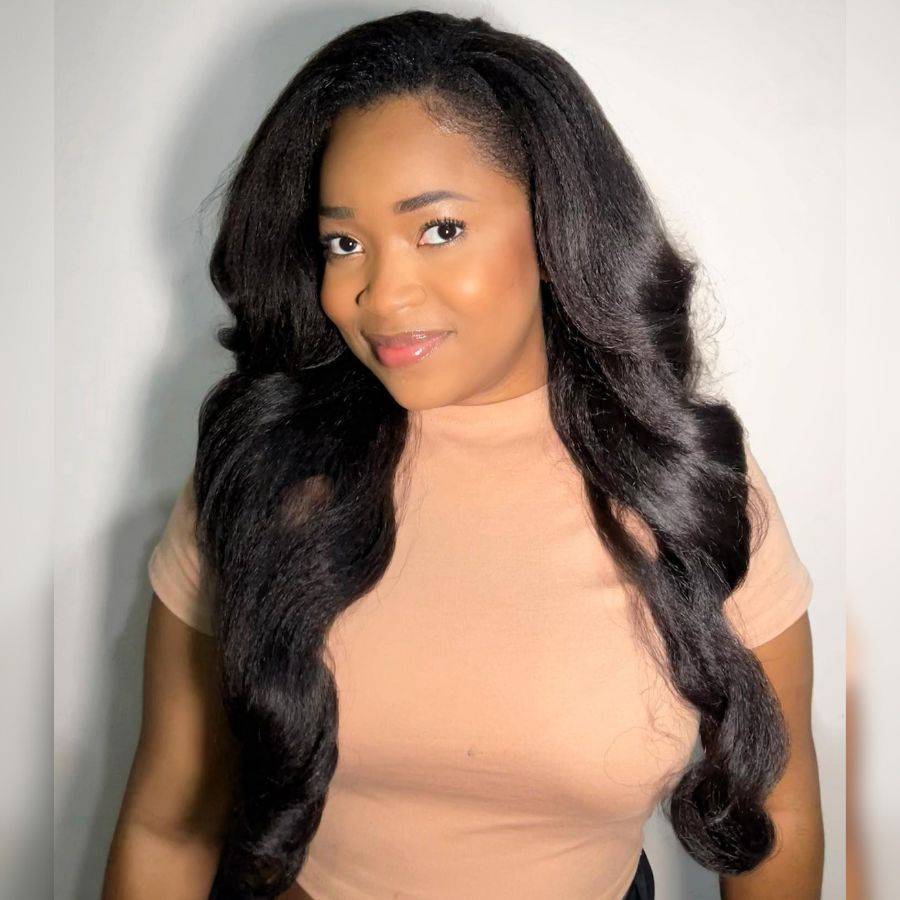 WOWANGEL Wear Go Kinky Straight Wig with voluminous natural black waves, worn by model to show full length and seamless hairline.