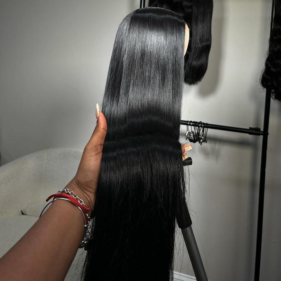 Hand holding WOWANGEL HD Lace Wig to display the long, glossy jet black strands and high-quality lace frontal construction.