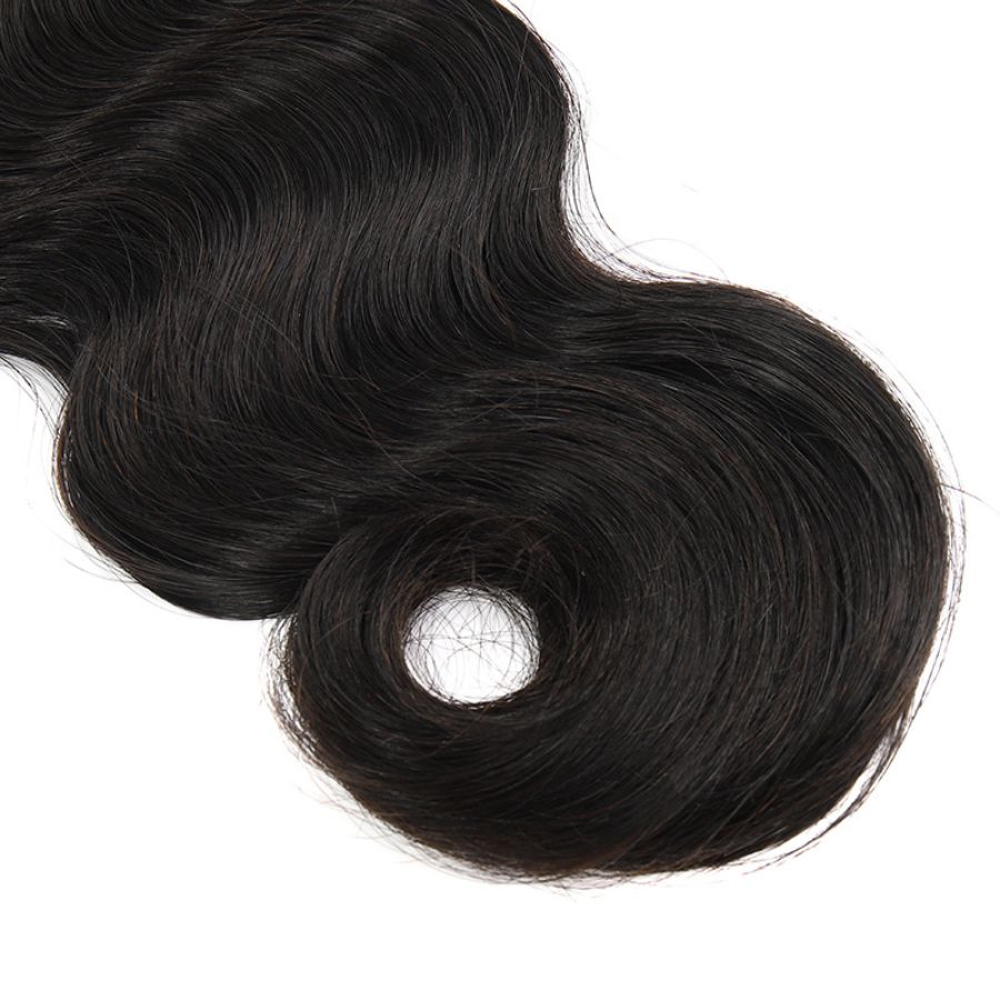 Detailed view of the curled end of a body wave Burmese virgin hair bundle, showcasing its natural and bouncy texture.