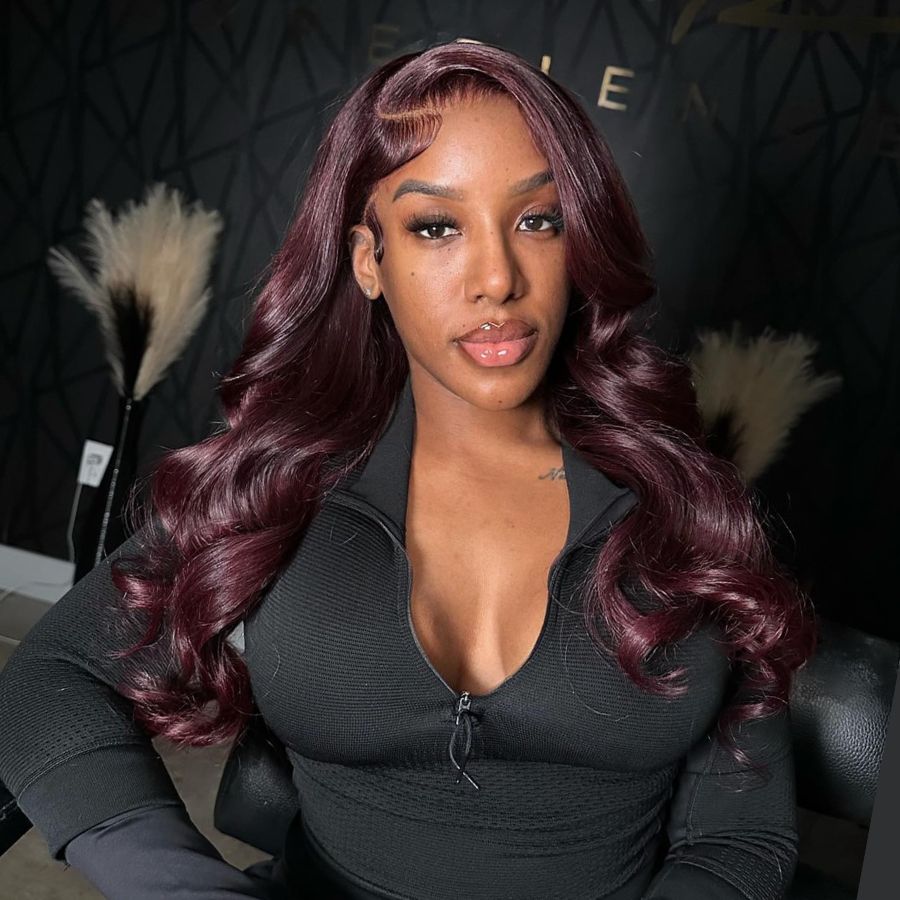 Model with deep burgundy WOWANGEL 13x6 Lace Front Wig styled in voluminous curls, enhancing a glamorous and elegant appearance.