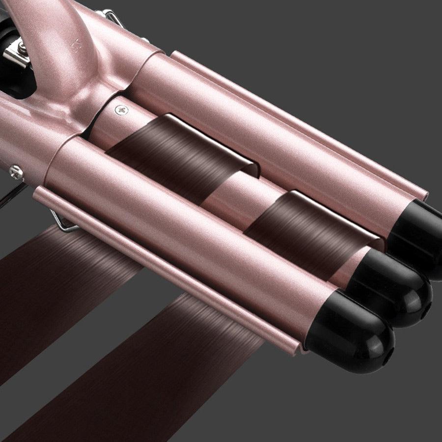 Close-up of curling iron barrel with hair