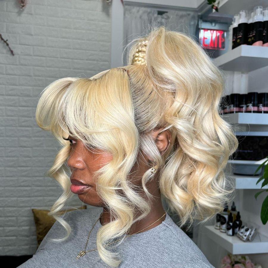 Blonde wig styled in a high ponytail with waves