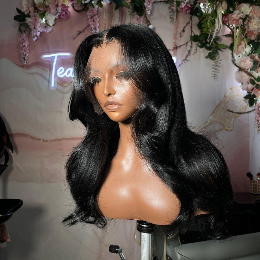 Front view of jet black body wave wig on mannequin