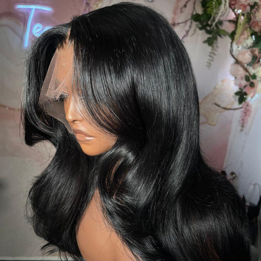 Side profile of jet black body wave wig on mannequin